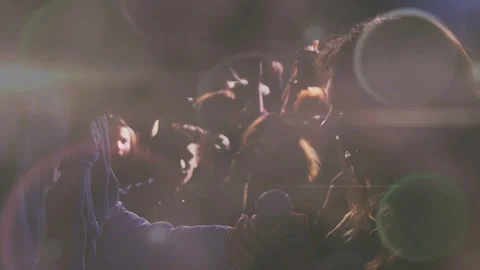 Performer offering mic to fan to sing at concert; phones filming, animated Vidéo 333936770