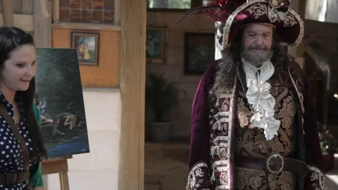 Performer in Pirate Costume Interacting with Visitors at Renaissance Faire Stock Footage 345275558