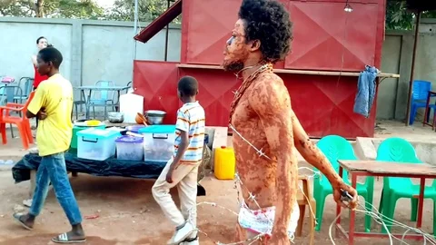 Performer "Snake" walks with barber wire Stock Footage 80740360