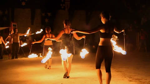 Performers handle fire cups and lit torches in front of the audience Vidéo 36371720