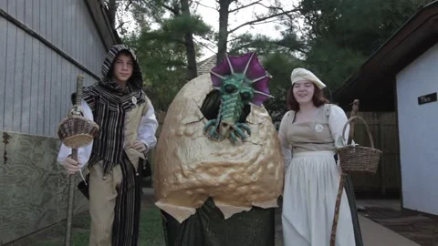 Performers in Medieval Costumes Posing with Dragon in Egg Stock Footage 345278889