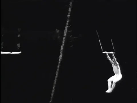 Performers put on a show on the flying trapeze at a circus in the 1930s. Stock Footage 75199737