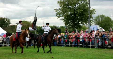 Performing acrobatics stunts on horseback by Cossacks Stock Footage 66186197