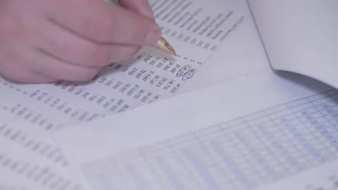 Performing an Analysis of Data using traditional Pen and Paper methodology Stock Footage 306618188