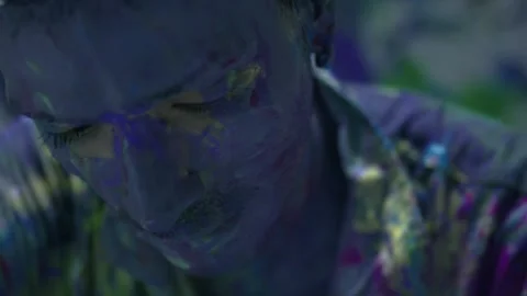 Performing art of a man dancing bathed in colored paint_close up shot Stock Footage 255352802