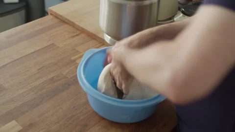 Performing coil fold technique on homemade artisan sourdough bread dough Stock Footage 343792589
