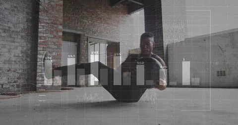 Performing core-strength exercise man bouncing medicine ball in warehouse, with 스톡 사진