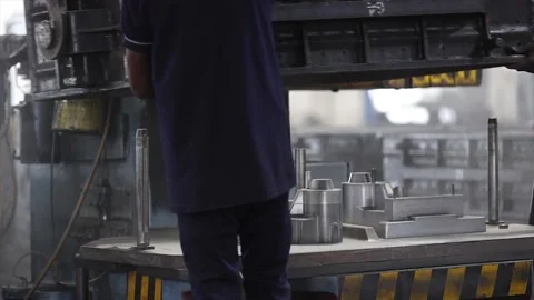 Performing crucial sand casting operations on a production line in a Rajkot Stock Footage 320946763