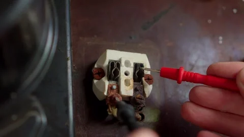 Performing Electrical Testing with a Multimeter on an Old Terminal Block for Stock Footage 308740175