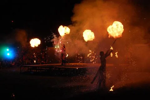 Performing fireshow at night surrounded by a crowd of people Stock Photos