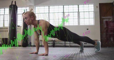 Performing push-ups, woman exercising over financial data processing animation 動画素材 305220563