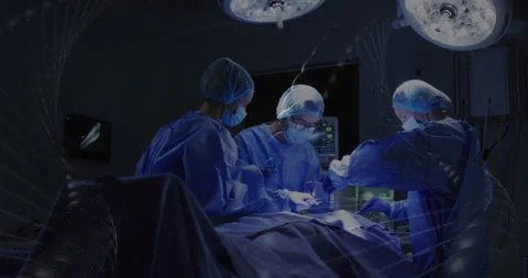 Performing surgery, surgeons in operating room under bright surgical lights Video stock 303842053
