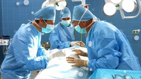 Performing surgery, surgical team in gowns using tools at OR table after Stock Footage 331593537