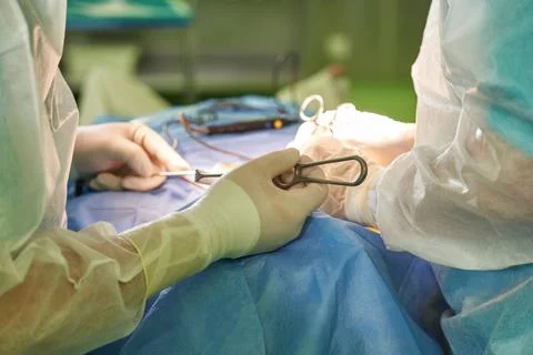 Performing a surgical operation close-up. work of surgeons in the operating room Stock Photos