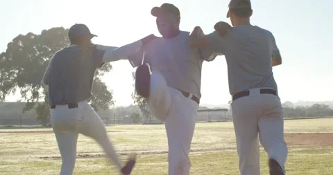 Performing synchronized warm-up kicks across outfield, Diverse male teammates Stock Footage 339160902