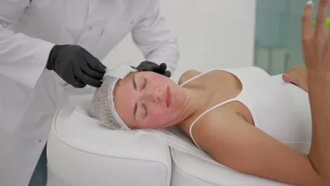 Performing thread face lifting in medical center. Cosmetologist performs thread Stock Footage 270004537