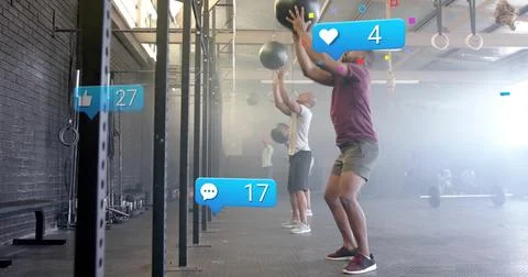Performing wall ball squats four adults inside fitness studio, with medicine Stock Photos
