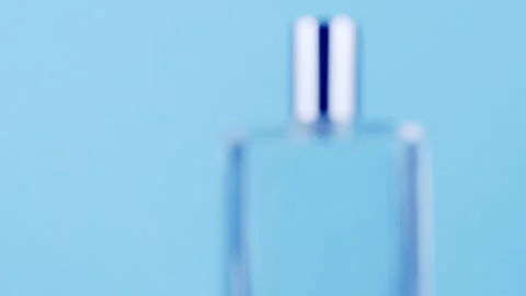 Perfume on blue rotating  camera Stock Footage 256651522