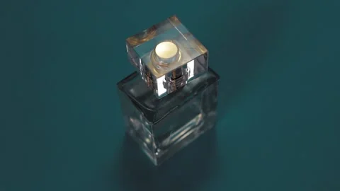 Perfume bottle and shining light flares on blue background Stock-Footage 147970685