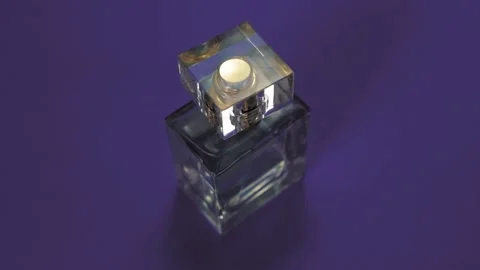 Perfume bottle and shining light flares on purple background Stock-Footage 147970907