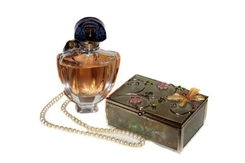 Perfume bottle, casket and a string of pearls Stock Photos