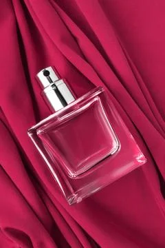 Perfume bottle on fabric Fotos Stock