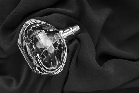 Perfume bottle on fabric Photos