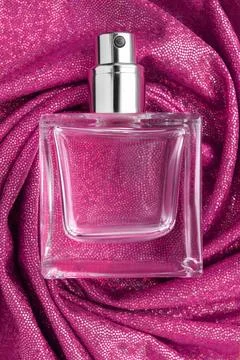 Perfume bottle on fabric Fotos Stock