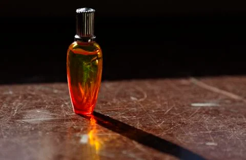 Perfume bottle at night in strong backlight with reflections Stock Photos