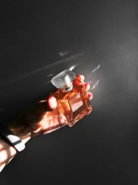 Perfume bottle sample in a hand Stock Photos