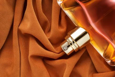 Perfume bottle on silk Fotos Stock