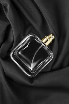 Perfume bottle on silk Photos