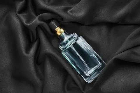 Perfume bottle on silk Fotos Stock