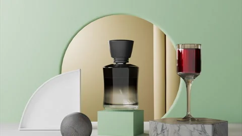 Perfume bottle sits on green base next to decorative glass filled with liquid Stock Footage 323730500