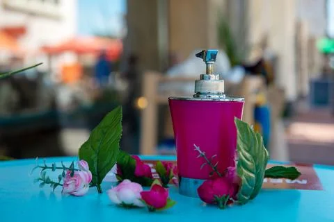 Perfume bottle spraying on the blue table Stock Photos