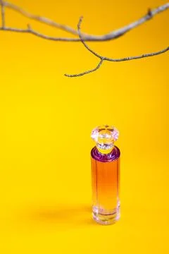 Perfume bottle on a yellow background. Copy space, layout, background. Stock Photos