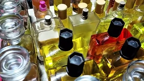 Perfume bottles assorted Collection with yellow and red hues 스톡 동영상 319053343