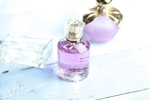 Perfume bottles on light background Stock Photos