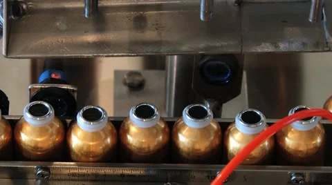 Perfume bottles move being filled at the production line. Video stock 61395225