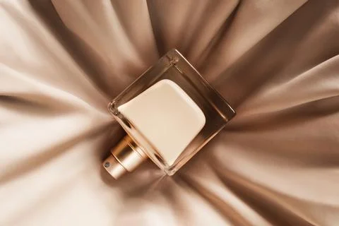 Perfume on draped fabric Stock Photos