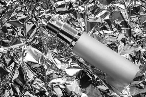 Perfume on foil background Stock Photos