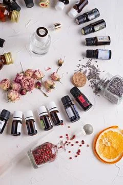 Perfume ingridients around white background. Perfumer, beauty and trendy conc Stock Photos