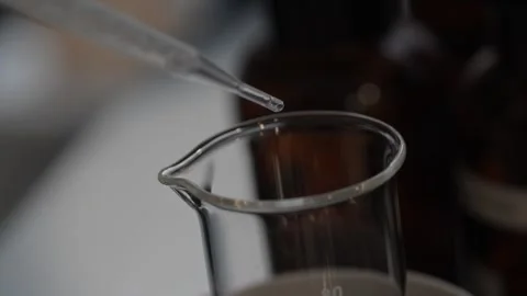 Perfume making process of dropping raw materials and blending into a flask Video stock 329165094