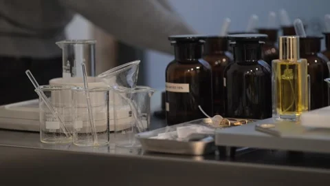 Perfume making process of dropping raw materials and blending into a flask Stock Footage 329165175