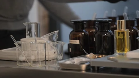 Perfume making process of dropping raw materials and blending into a flask Stock Footage 329165191
