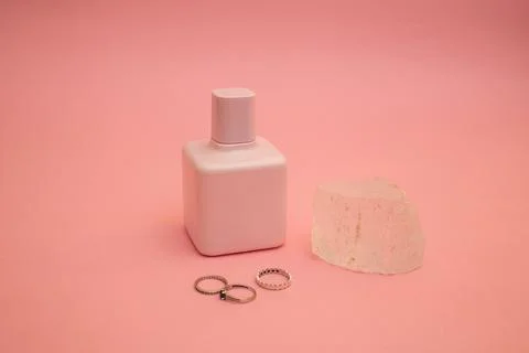Perfume on a pink background Stock Photos