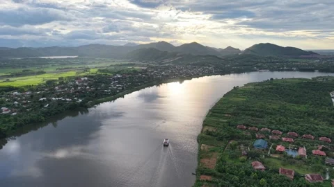 Perfume River sunset with mountain silhouettes aerial 4K Stock Footage 339863757