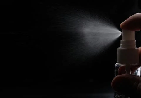 Perfume spray on black Stock Photos