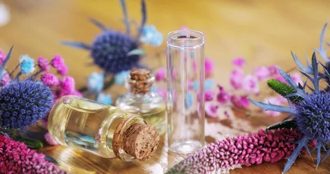 Perfumer creating new aroma liquid parfume pouring essential oil in glass vial. Stock Footage 127735460