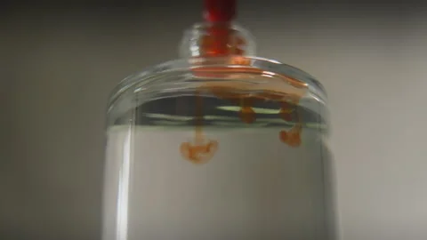 Perfumer pouring drops of oily scent into perfume in a glass bottle. Process of Stock Footage 170613968